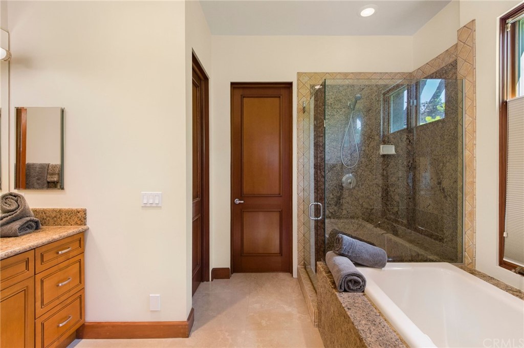 10 Smithcliffs Road Laguna Beach, CA 92651 - Photo 32 of 38 a bathroom with a tub shower sink and mirror