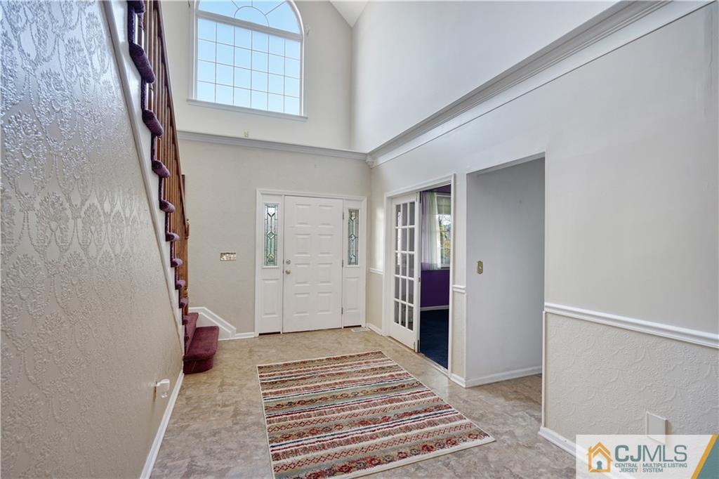104 Cruise Road Manahawkin, NJ 08050 - Photo 3 of 25 a view of a hallway with entryway and stairs