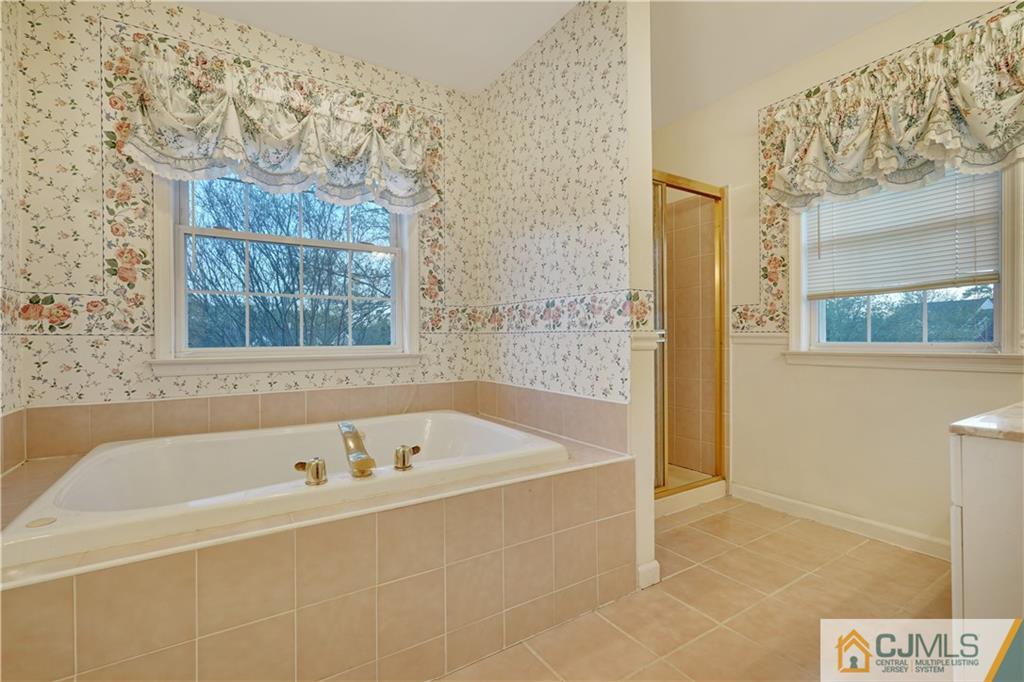 104 Cruise Road Manahawkin, NJ 08050 - Photo 22 of 25 a white bath tub sitting next to a shower