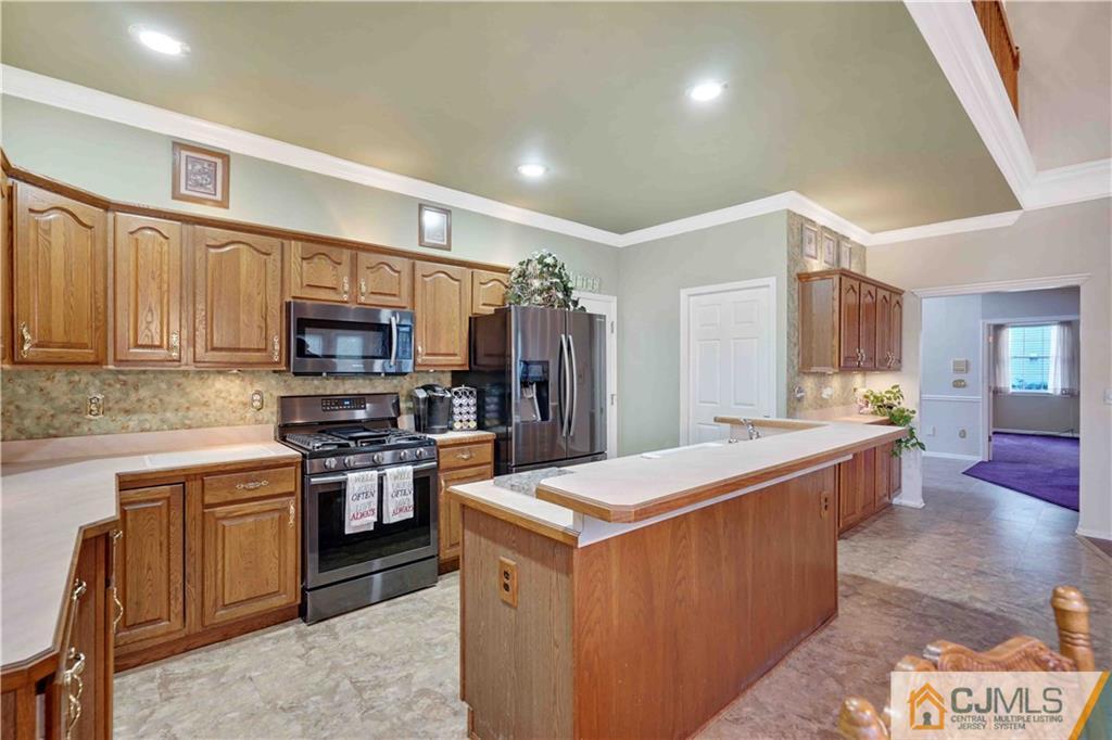 104 Cruise Road Manahawkin, NJ 08050 - Photo 8 of 25 a large kitchen with stainless steel appliances and a stove