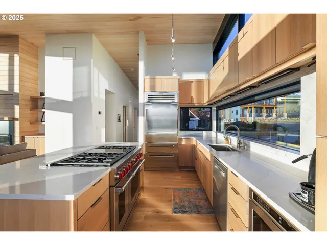 a kitchen with stainless steel appliances a sink a stove and a refrigerator