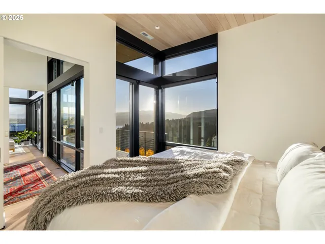a view of a bedroom with a bed and glass door