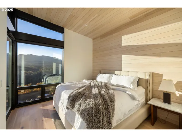 a bed sitting in a bedroom next to a window