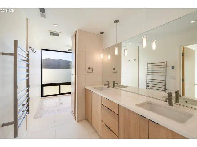 a bathroom with a sink double vanity and a shower