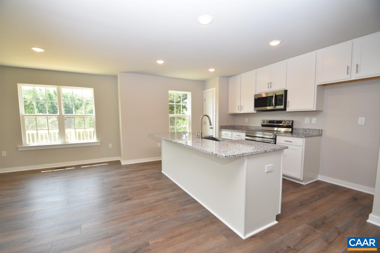 325 Gold Mine Road Palmyra, VA 22963 - Photo 7 of 28 a large kitchen with stainless steel appliances granite countertop a stove a sink and a microwave