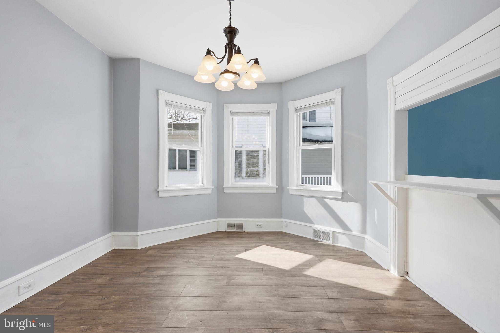 312 Pleasant Street West Hammonton, NJ 08037 - Photo 11 of 64 a view of an empty room with wooden floor and a window