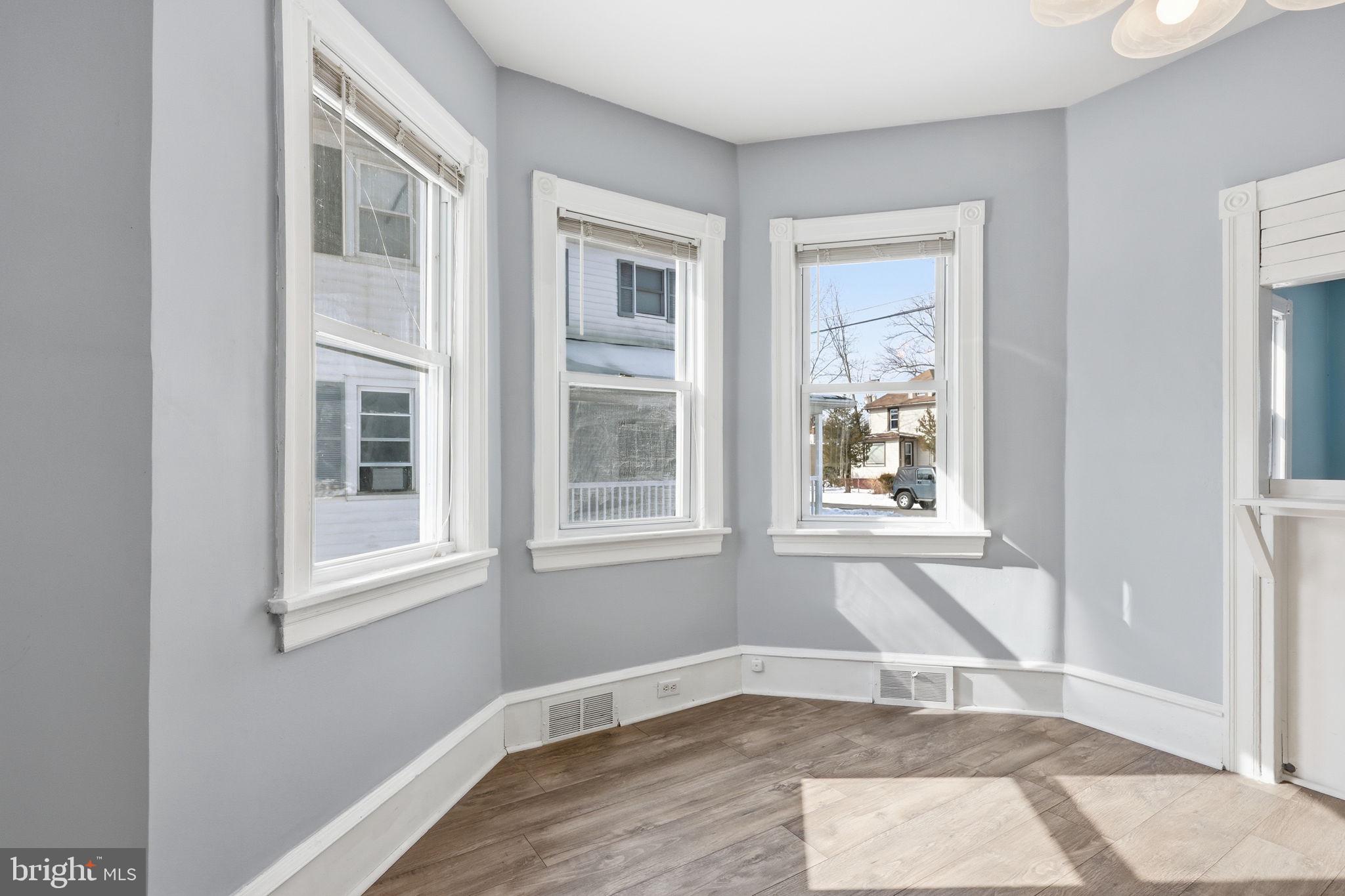 312 Pleasant Street West Hammonton, NJ 08037 - Photo 12 of 64 a view of an empty room with wooden floor and a window