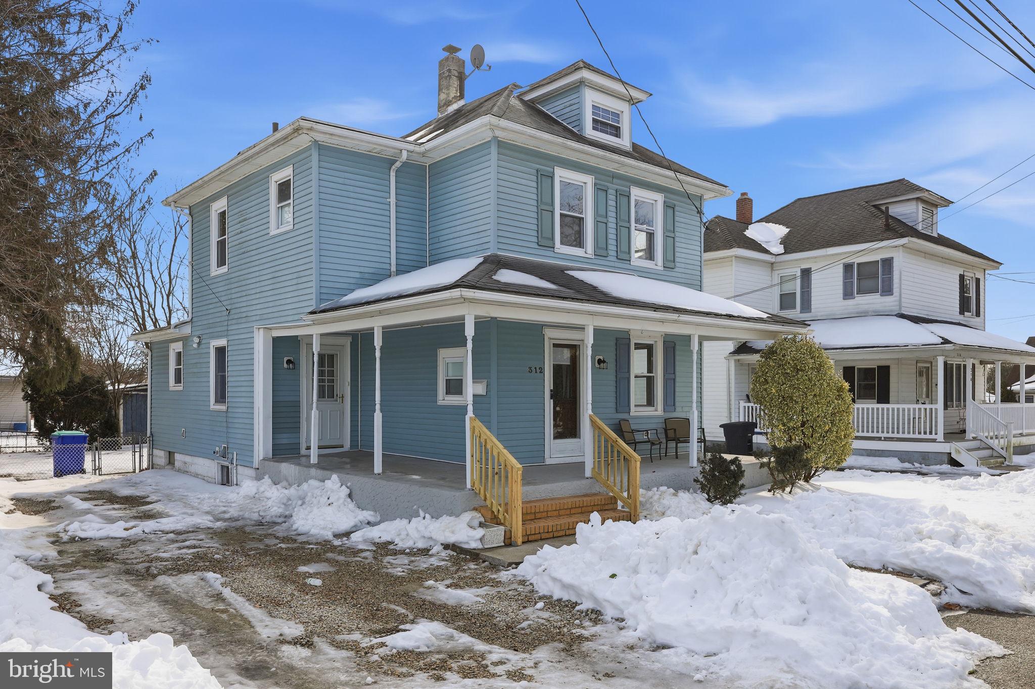 312 Pleasant Street West Hammonton, NJ 08037 - Photo 2 of 64 a front view of a house with a yard covered with snow