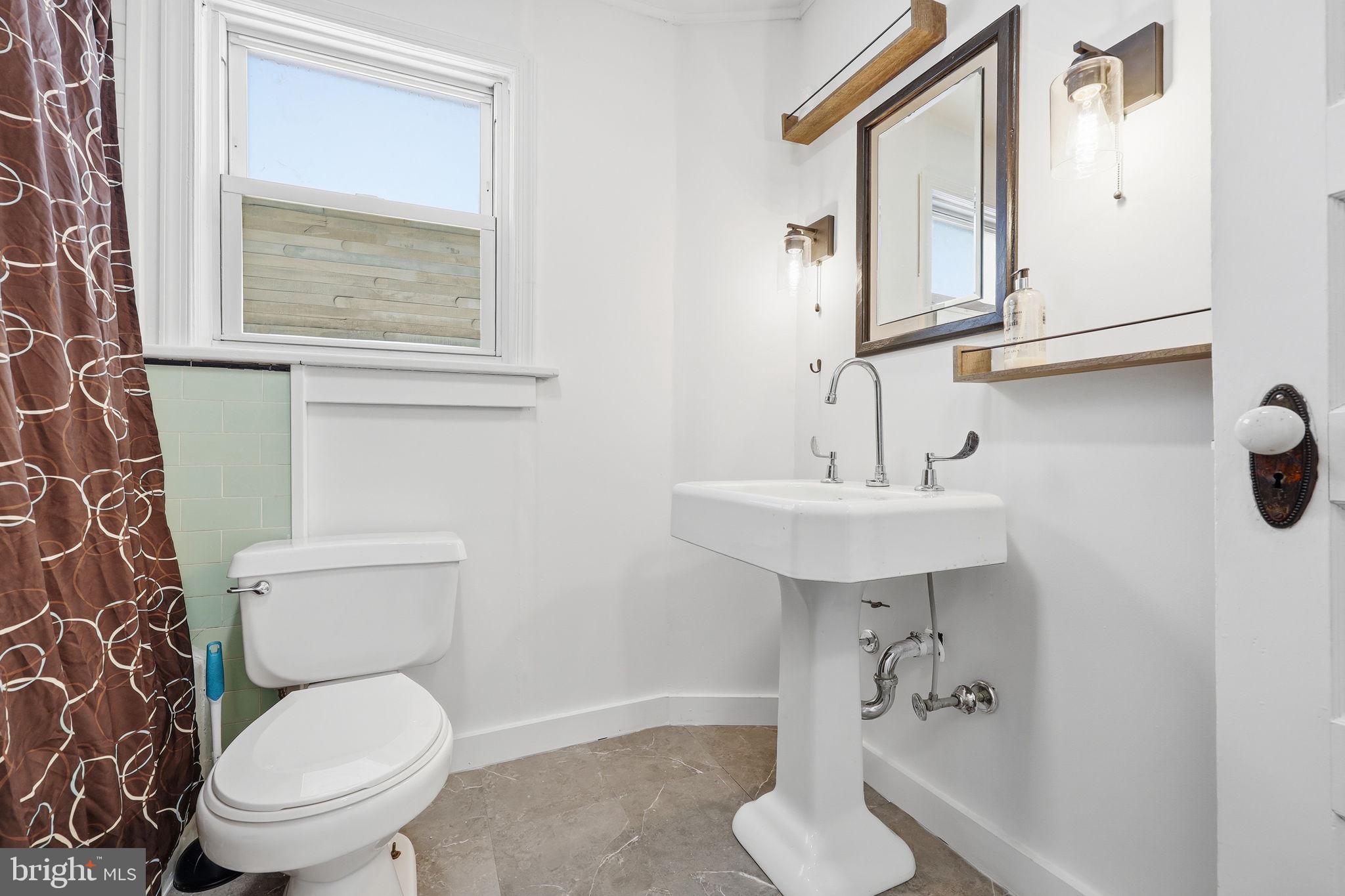 312 Pleasant Street West Hammonton, NJ 08037 - Photo 25 of 64 a bathroom with a toilet sink and mirror