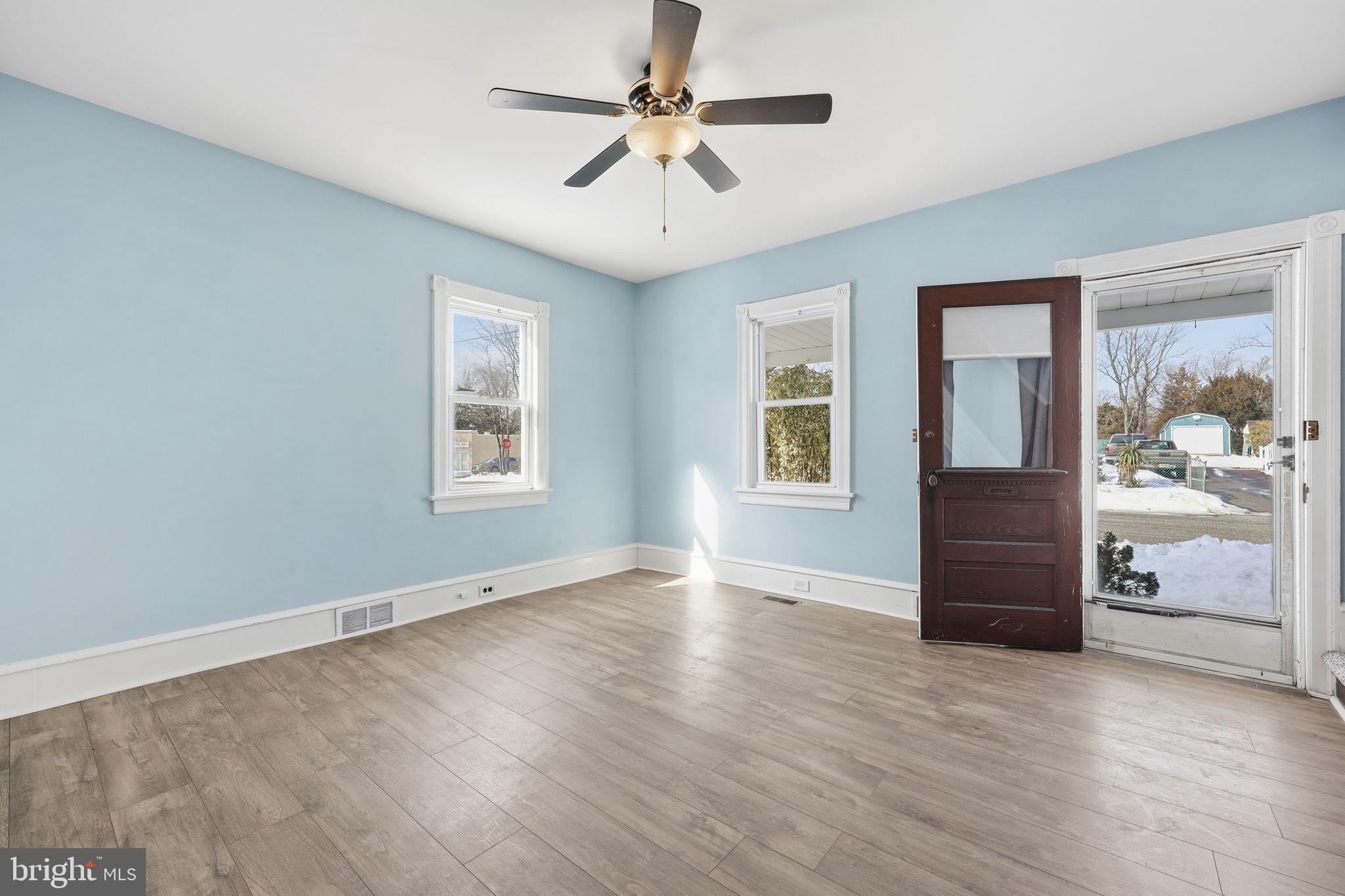 312 Pleasant Street West Hammonton, NJ 08037 - Photo 7 of 64 a view of an empty room with a window and wooden floor