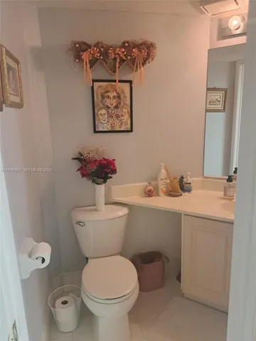 a white toilet sitting next to a bathroom sink