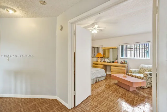 a bedroom with a bed couch and a window