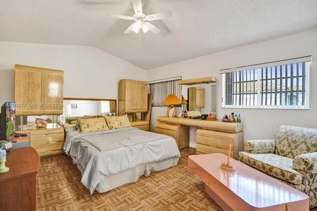 a bedroom with two beds and a chandelier