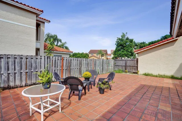 a view of a house with backyard and sitting area