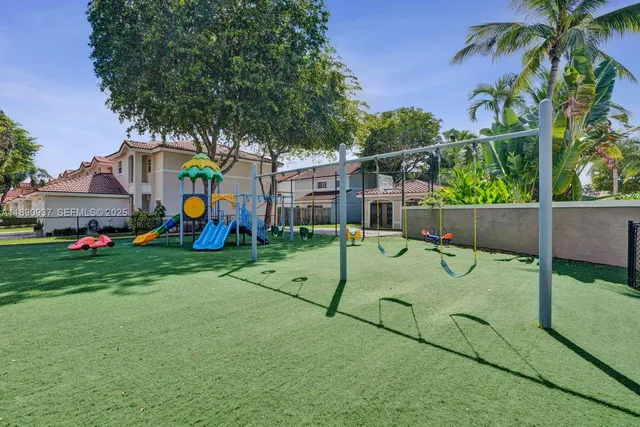 a backyard of a house with potted plants and palm tree