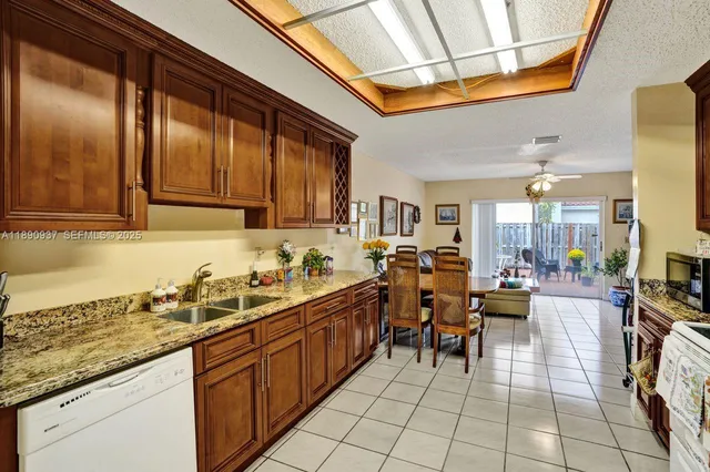 a kitchen with stainless steel appliances granite countertop a sink and cabinets
