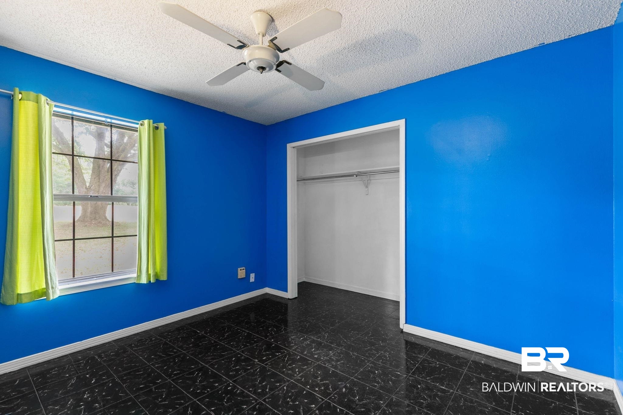 13653 Roberts Road Loxley, AL 36551 - Photo 21 of 33 Room featuring blue walls and black tile flooring
