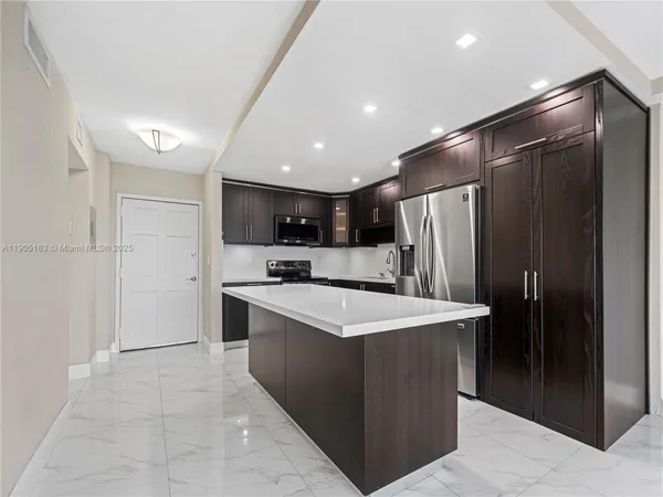 a kitchen with stainless steel appliances a refrigerator a sink dishwasher with a stove and refrigerator