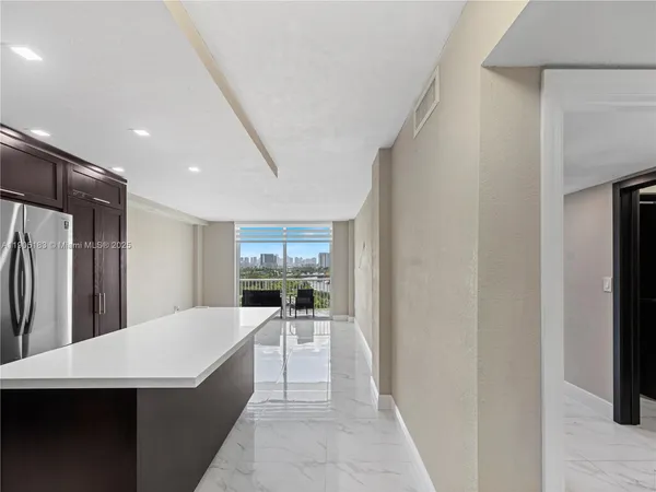 a kitchen with stainless steel appliances a refrigerator and a sink