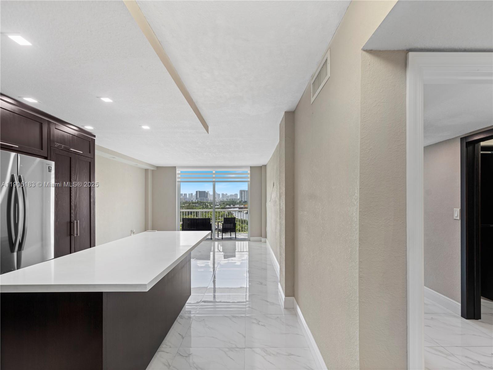 1800 Northwest 24th Avenue, Unit 1019 Miami, FL 33125 - Photo 7 of 14 a kitchen with stainless steel appliances a refrigerator and a sink