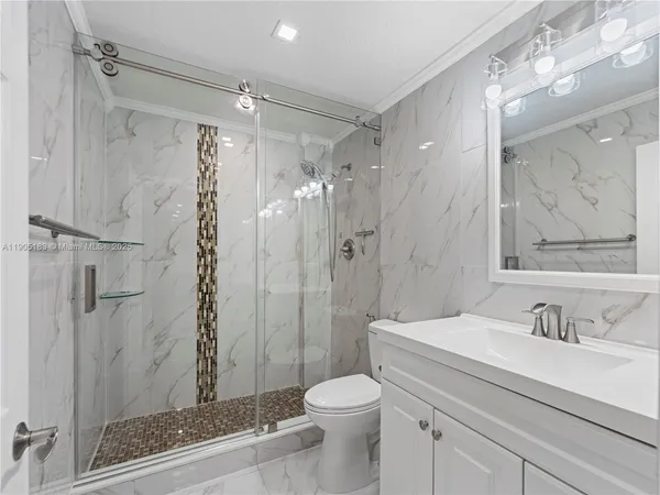 a bathroom with a sink toilet and shower