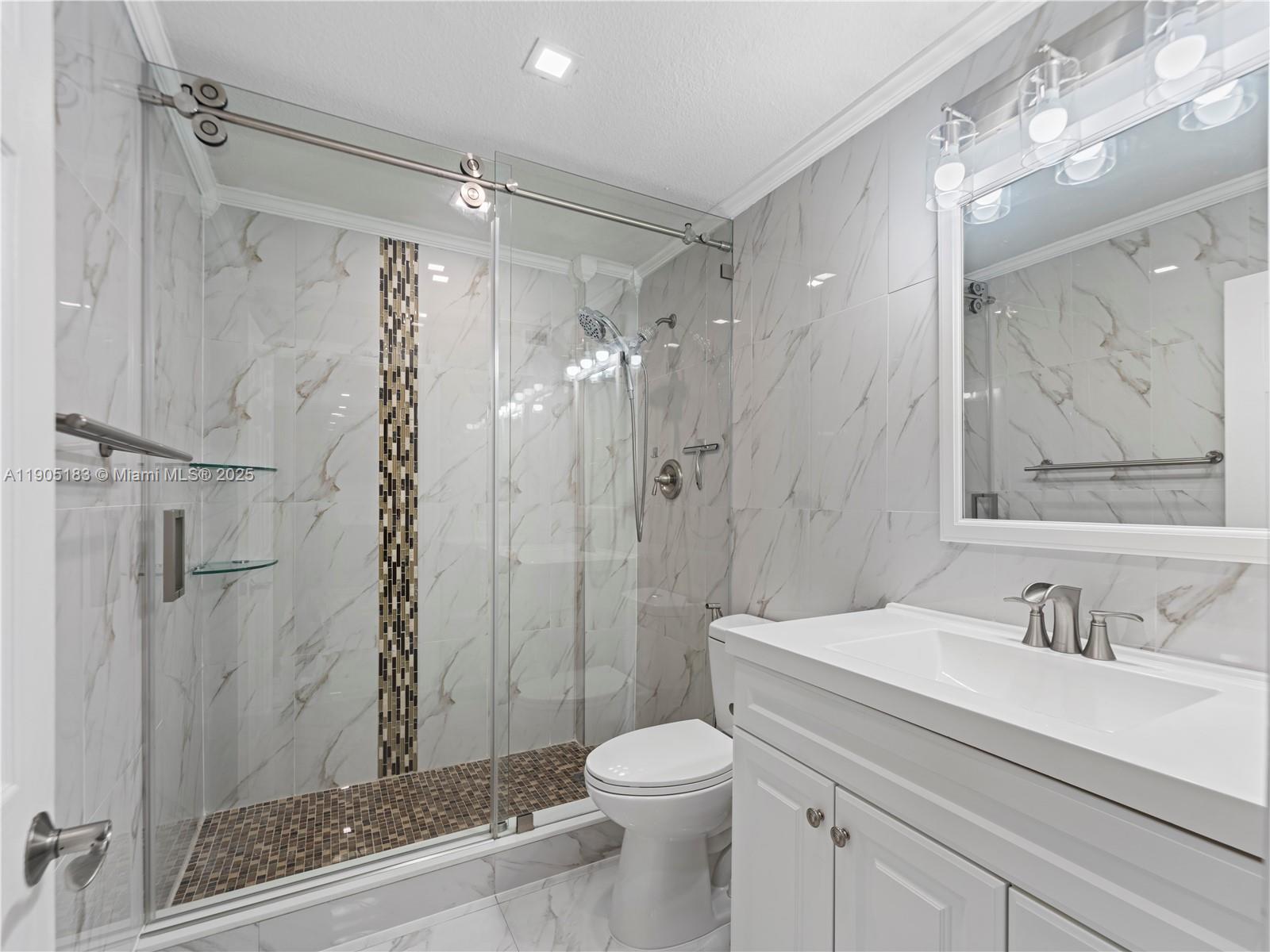 1800 Northwest 24th Avenue, Unit 1019 Miami, FL 33125 - Photo 9 of 14 a bathroom with a sink toilet and shower