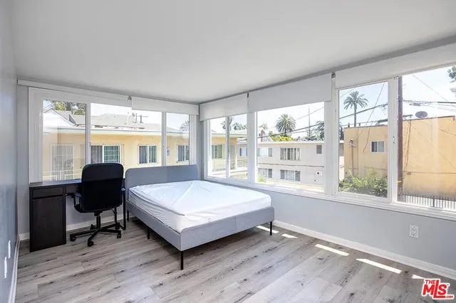 a living room with a large window bed and table