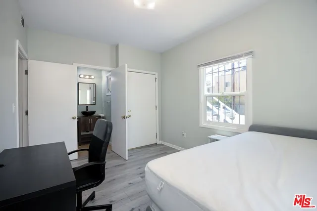 a bedroom with a bed and a window