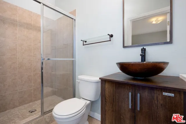 a bathroom with a toilet a sink and shower