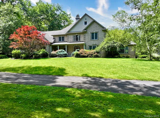 a front view of a house with a garden and yard