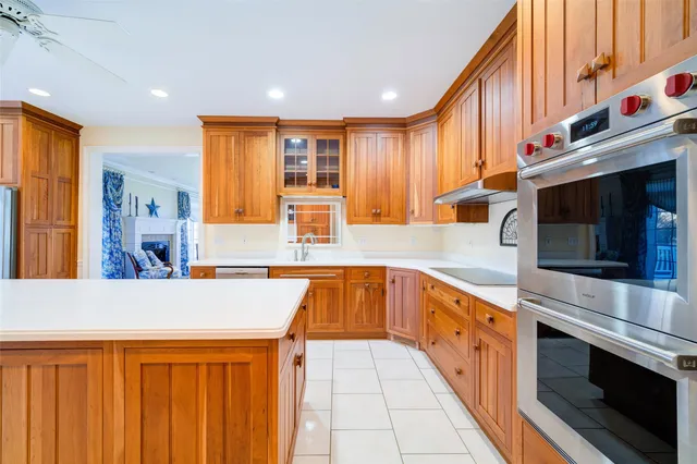 a kitchen with stainless steel appliances granite countertop a sink and a stove