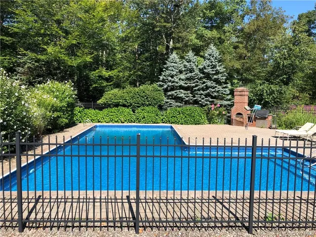 a view of deck with wooden fence and trees