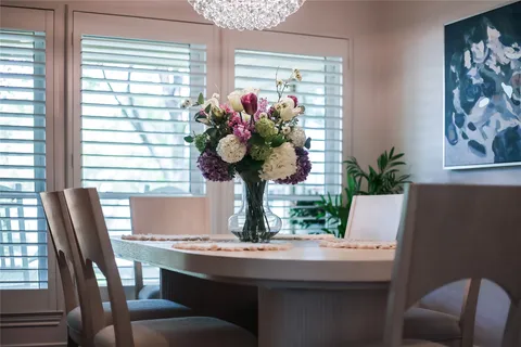 a view of a dining room with furniture and window