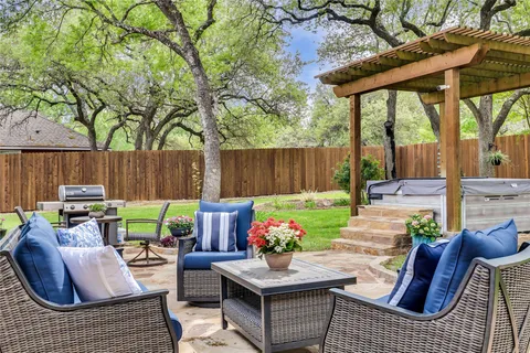 a view of backyard of house with seating space