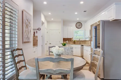 a large kitchen with furniture and a refrigerator