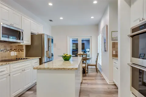 a kitchen with sink refrigerator and microwave