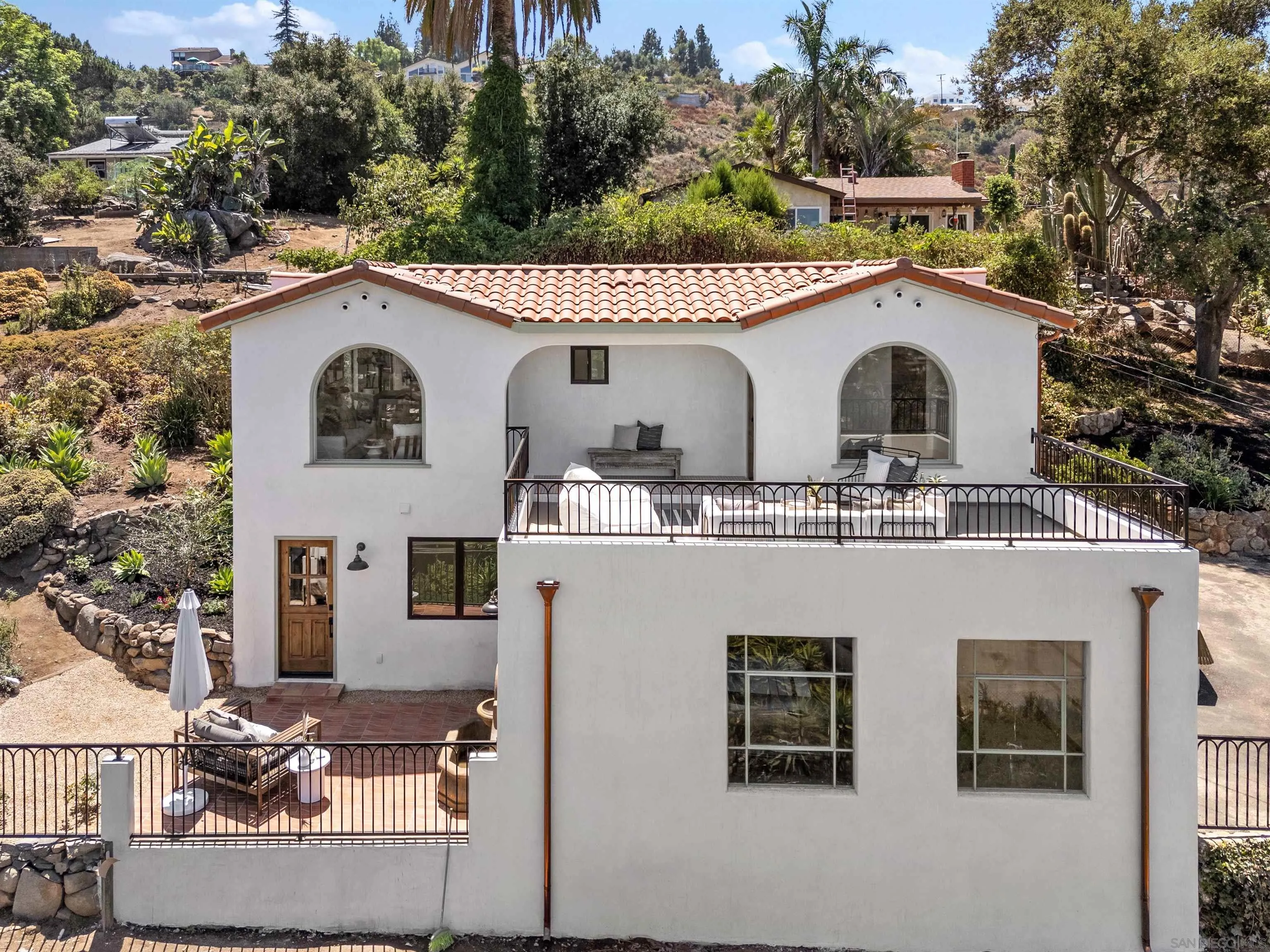 1262 Horizon Ridge El Cajon, CA 92020 - Photo 43 of 68 a view of a white house with large windows and a outdoor space