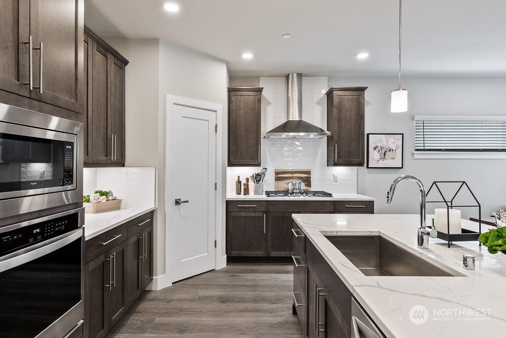 22829 20th Place West Bothell, WA 98021 - Photo 2 of 31 a kitchen with a sink cabinets and stainless steel appliances