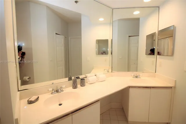 a bathroom with a sink vanity and mirror