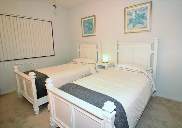 a bedroom with bed and cupboard