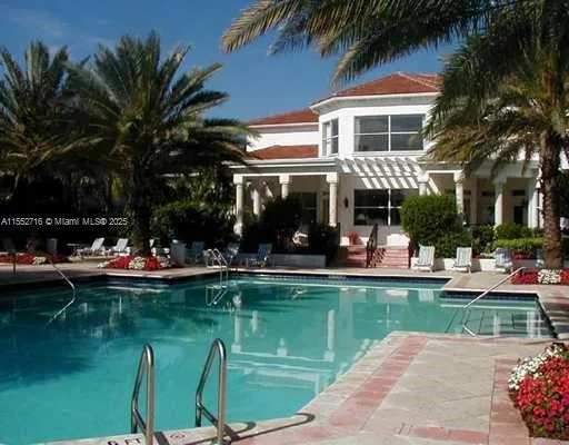 a view of a swimming pool with a table and chairs in patio