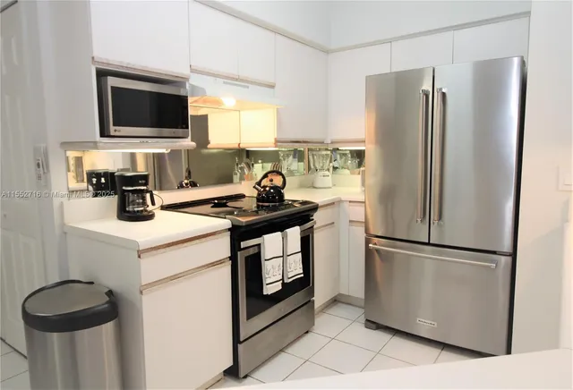 a kitchen with a refrigerator stove and microwave