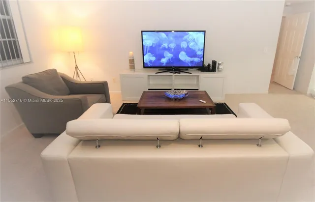 a living room with furniture and a rug