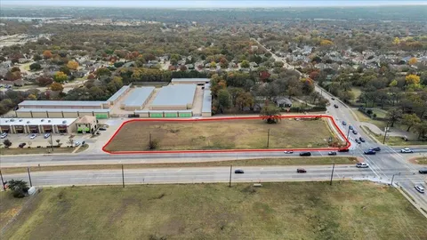 an aerial view of a houses with a city view