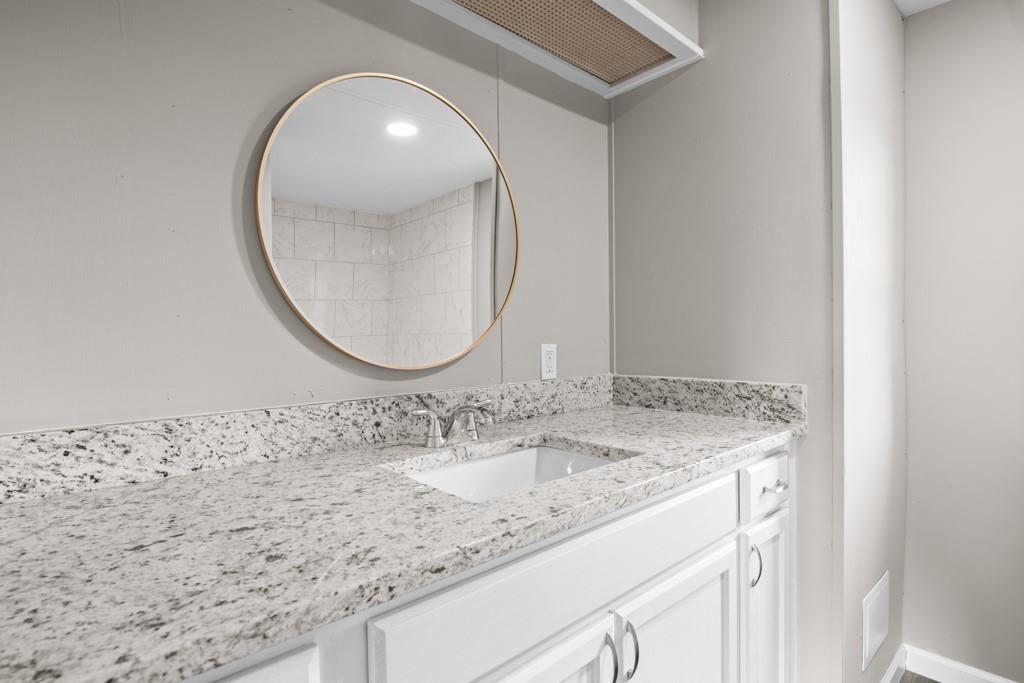 710 Athens Road Lexington, GA 30648 - Photo 14 of 17 a bathroom with a granite countertop sink and a mirror