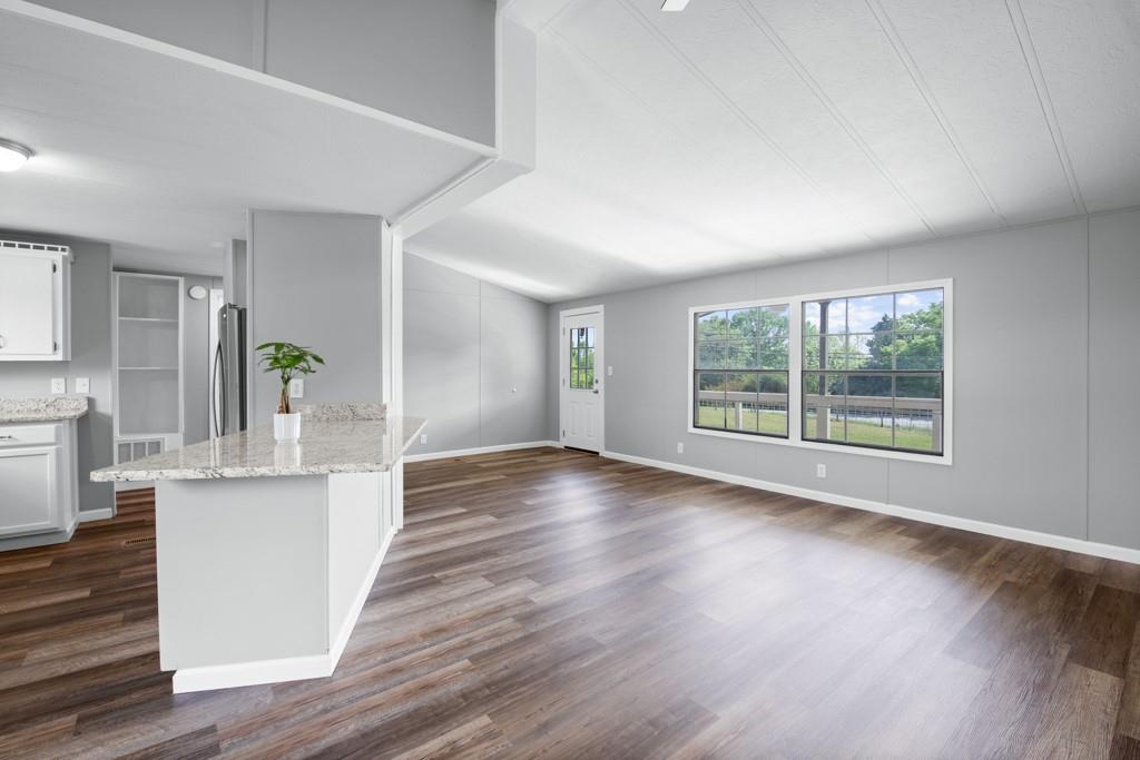 710 Athens Road Lexington, GA 30648 - Photo 5 of 17 a view of a kitchen with wooden floor and a window