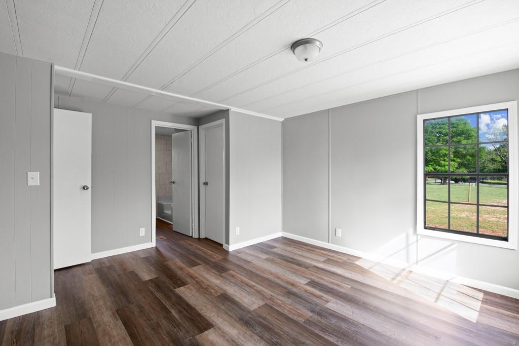 710 Athens Road Lexington, GA 30648 - Photo 9 of 17 a view of an empty room with wooden floor and window