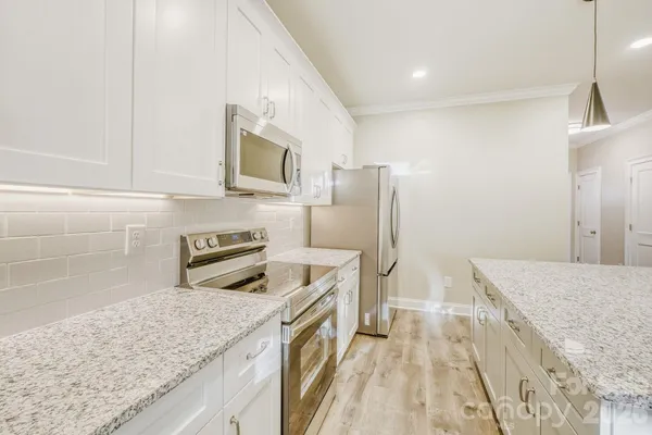 a kitchen with a sink stove and refrigerator
