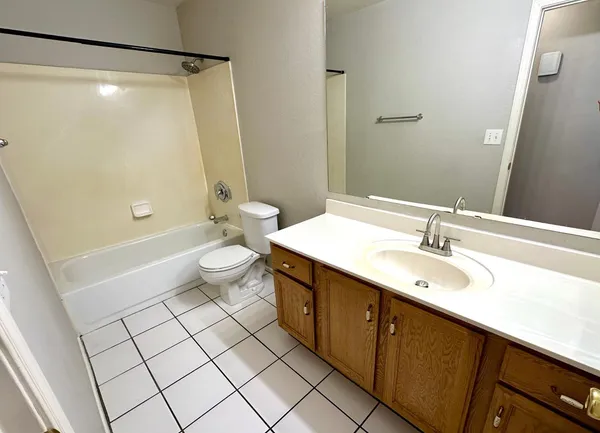 a bathroom with a double vanity sink mirror and toilet