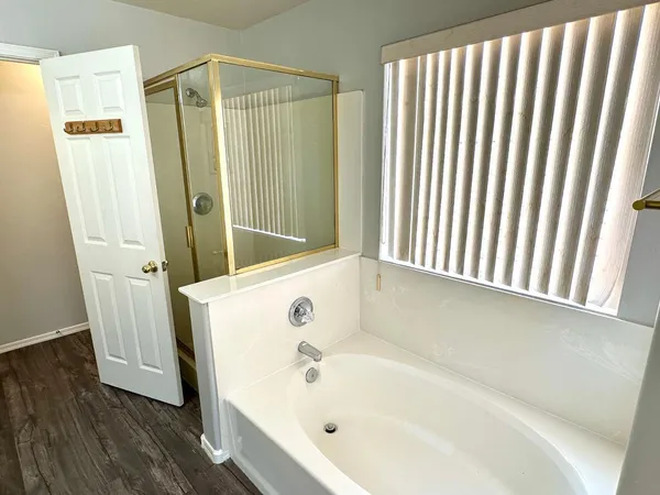 a bathroom with a bathtub and a shower